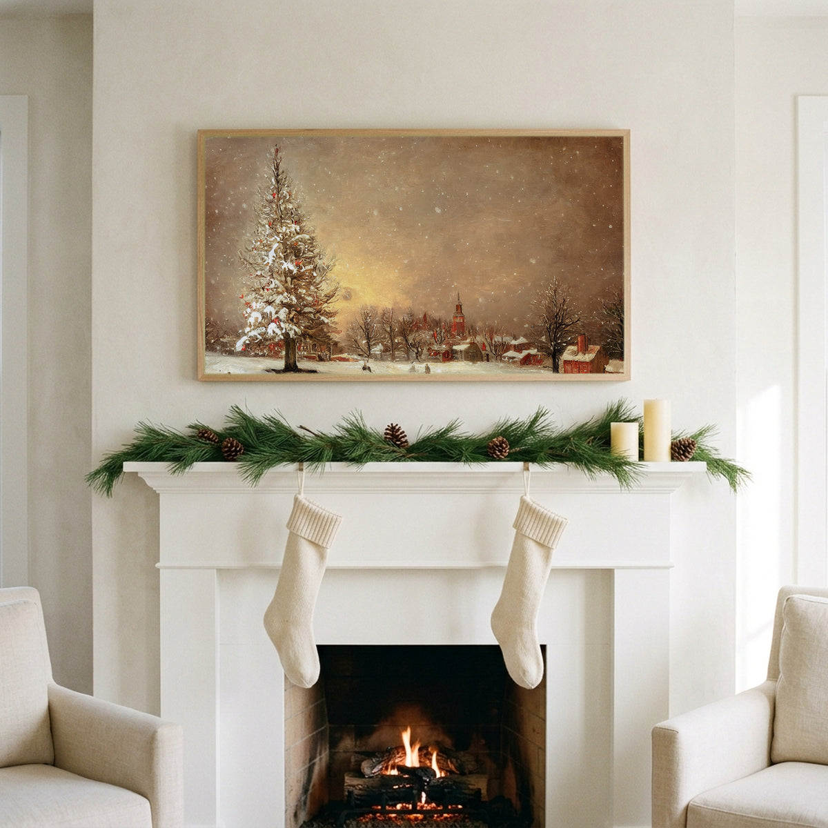 Snowy tree and village art on a TV above a white fireplace with a pine garland and cream stockings