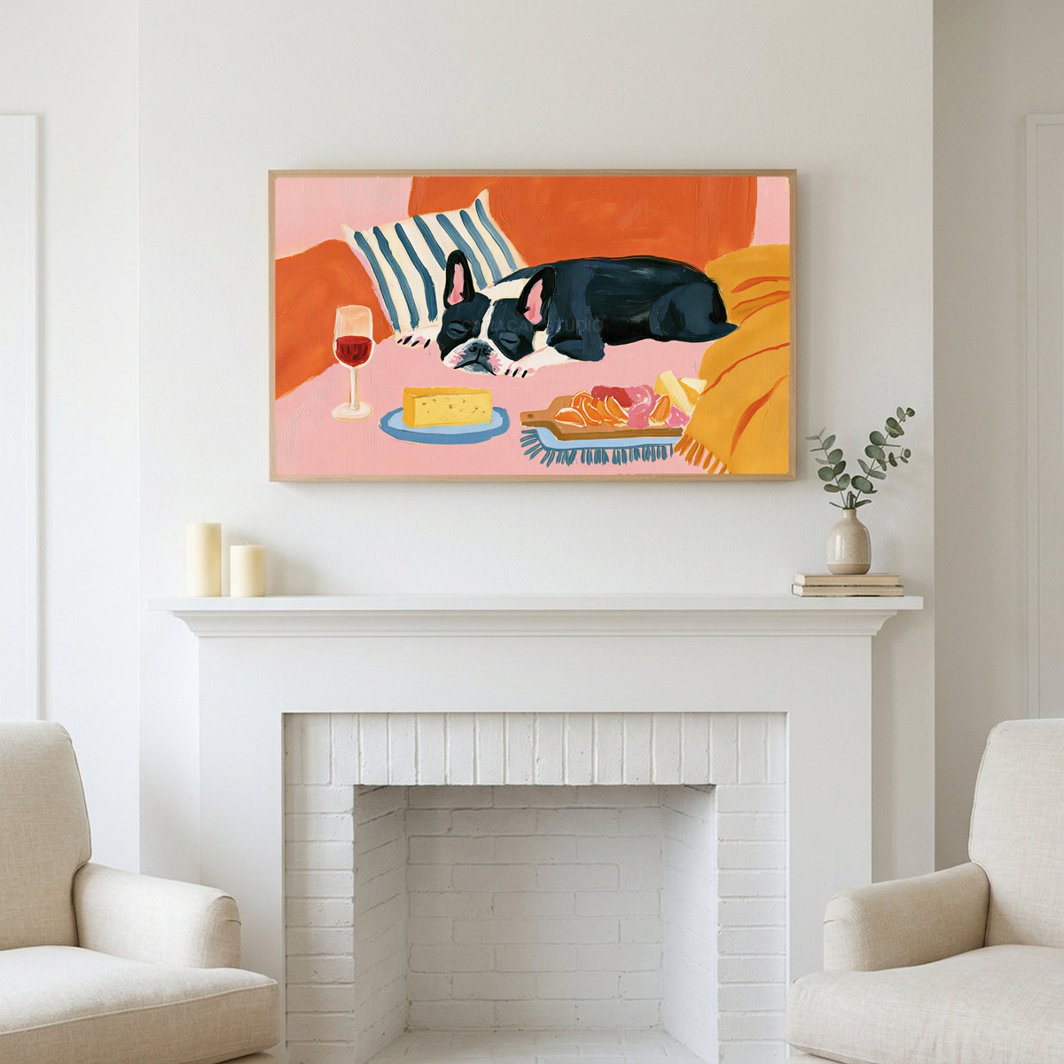 Frame TV art above a white fireplace with candles and eucalyptus on the mantel