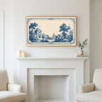 Blue toile garden art above a white fireplace with candles and eucalyptus on the mantel