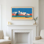 Mediterranean village art above a white fireplace with candles and eucalyptus on the mantel