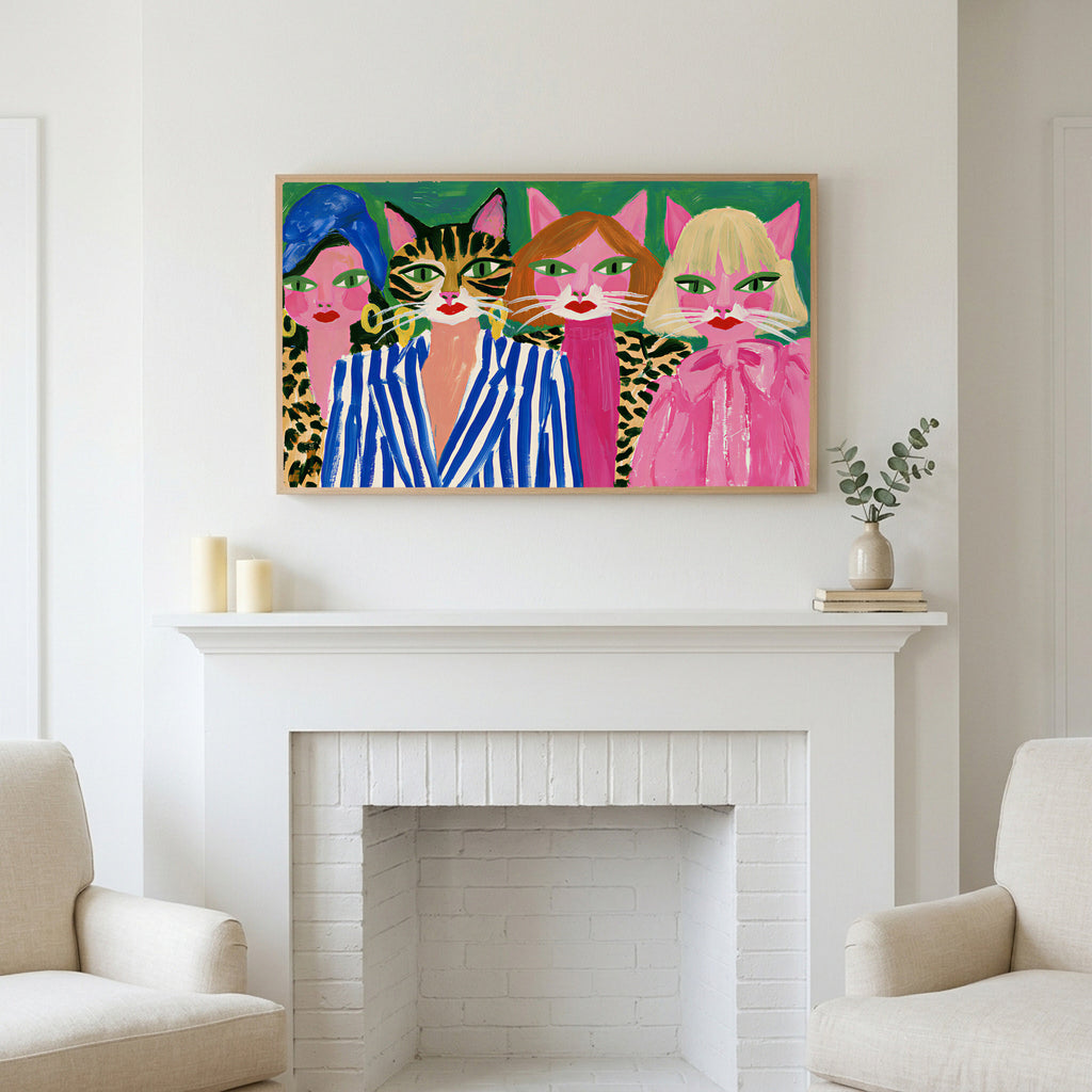 Cat ladies art above a white fireplace with candles and eucalyptus on the mantel