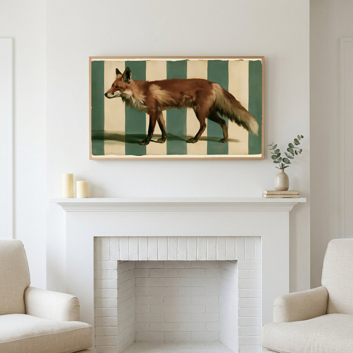 Red fox art above a white fireplace with candles and eucalyptus on the mantel