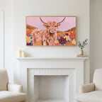 Highland cow in fall leaves art above a white fireplace with candles and eucalyptus on the mantel