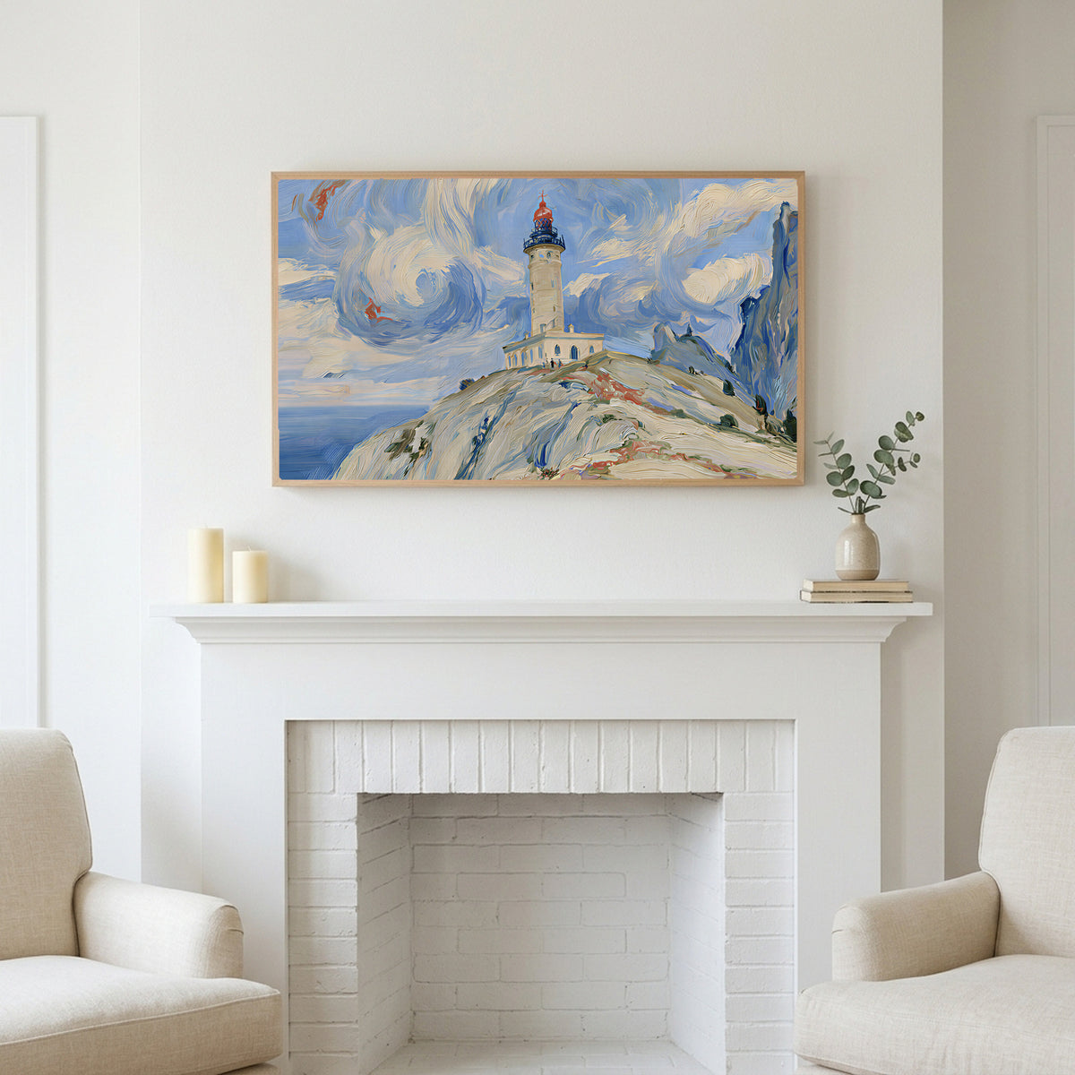 Lighthouse on a cliff art above a white fireplace with candles and eucalyptus on the mantel