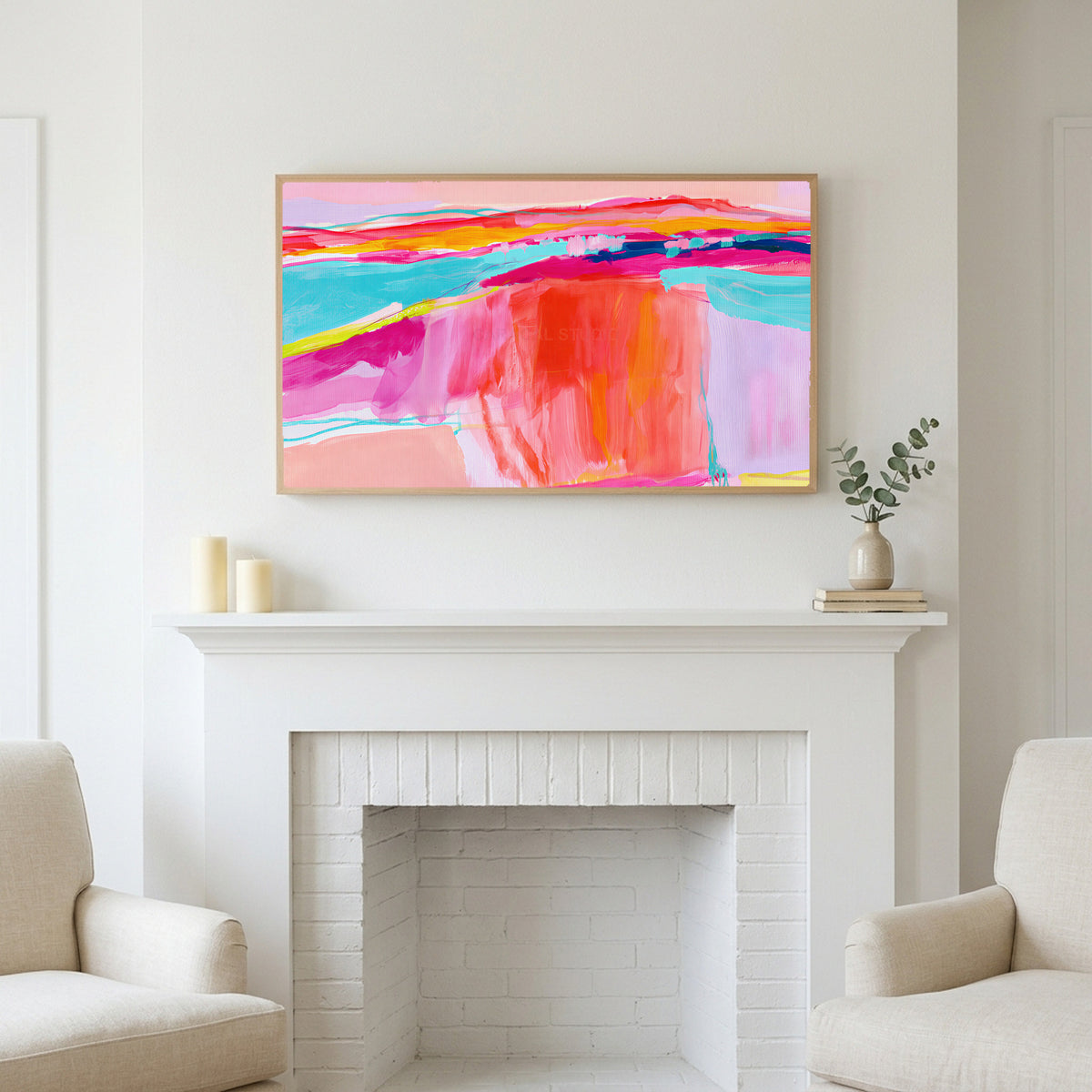 Pink abstract horizon art above a white fireplace with candles and eucalyptus on the mantel