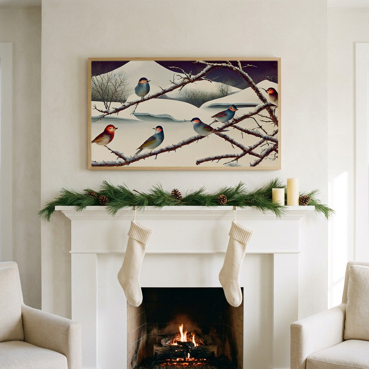 Songbirds on snowy branches art on a TV above a white fireplace with a pine garland and cream stockings