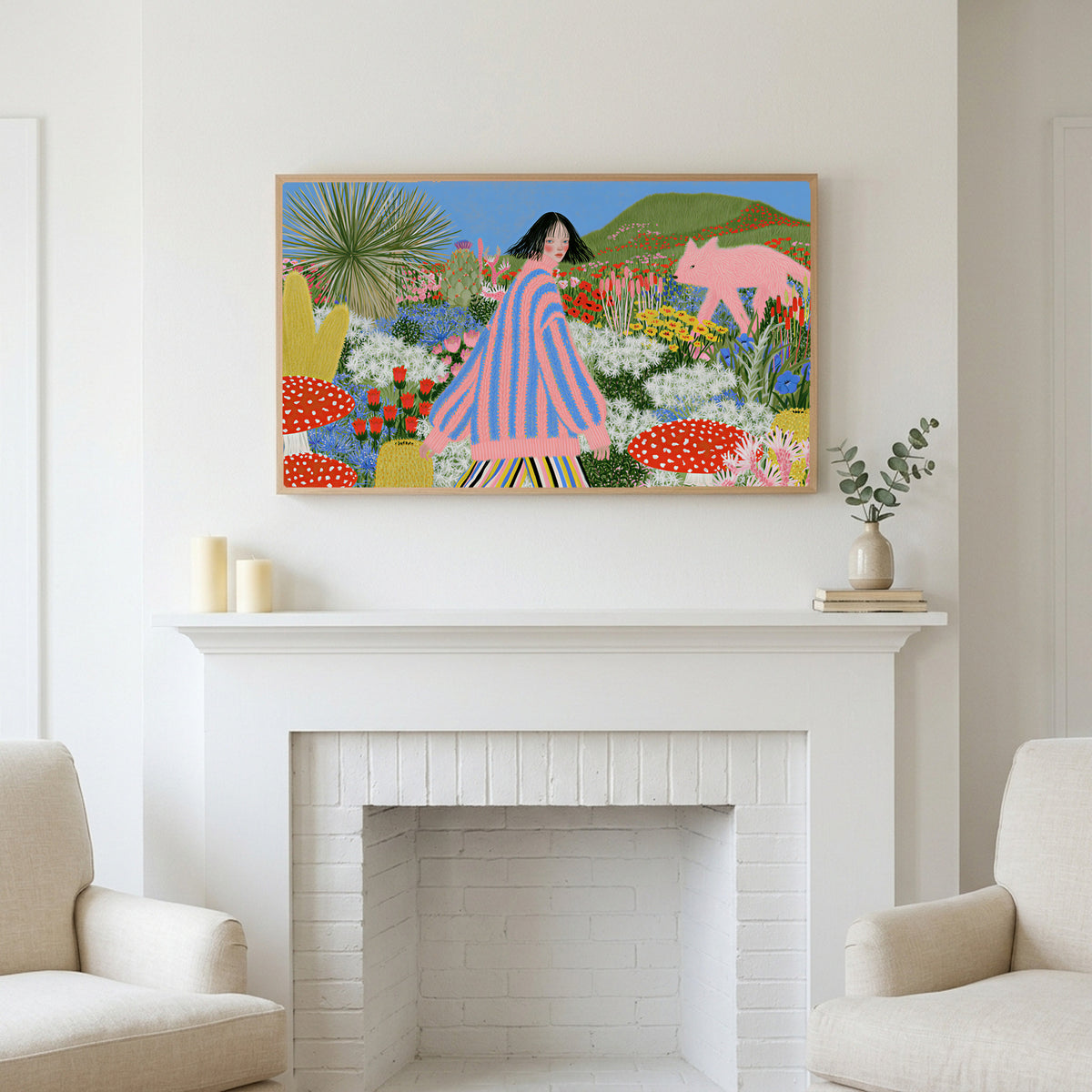 Flower garden and pink fox art above a white fireplace with candles and eucalyptus on the mantel