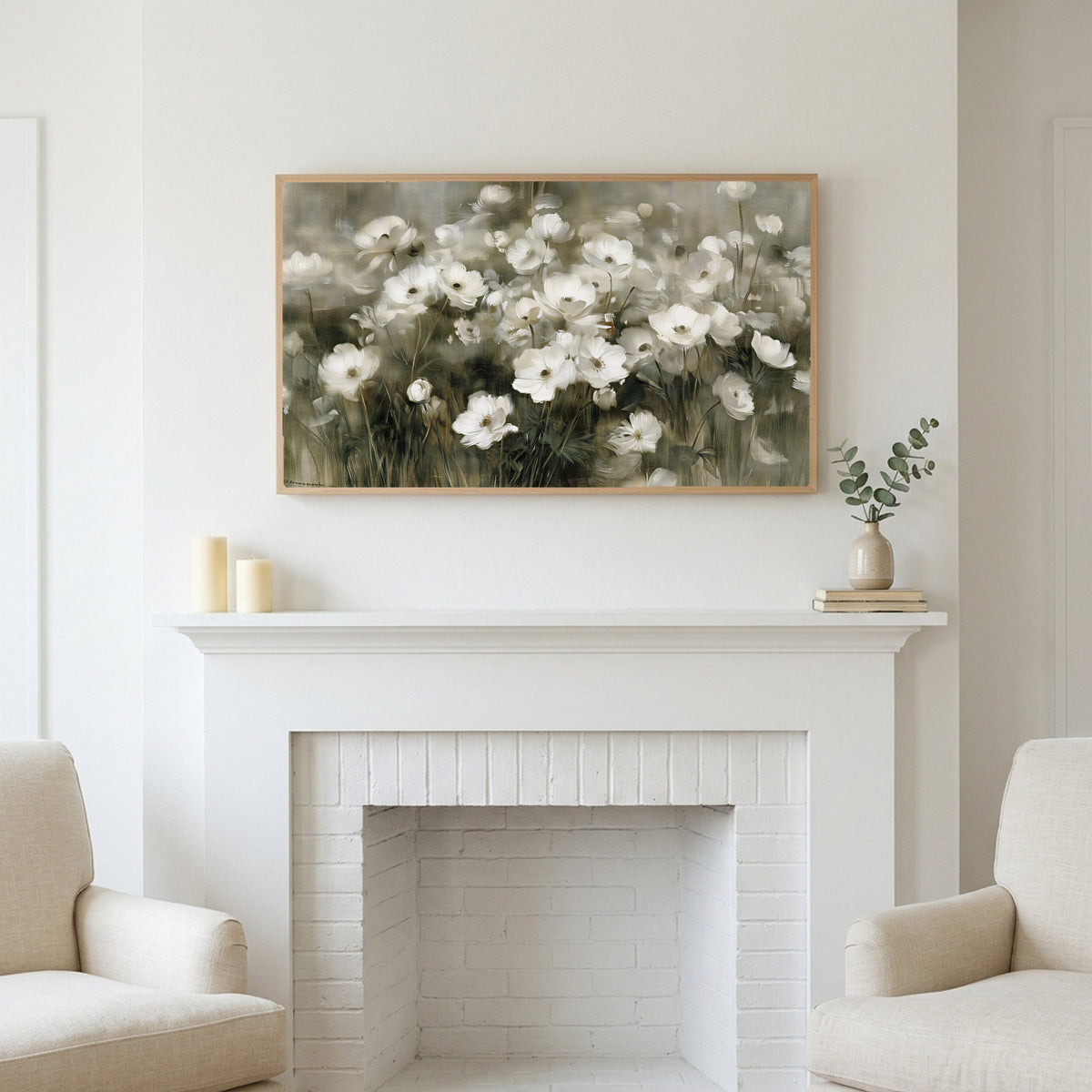 White anemone field art above a white fireplace with candles and eucalyptus on the mantel