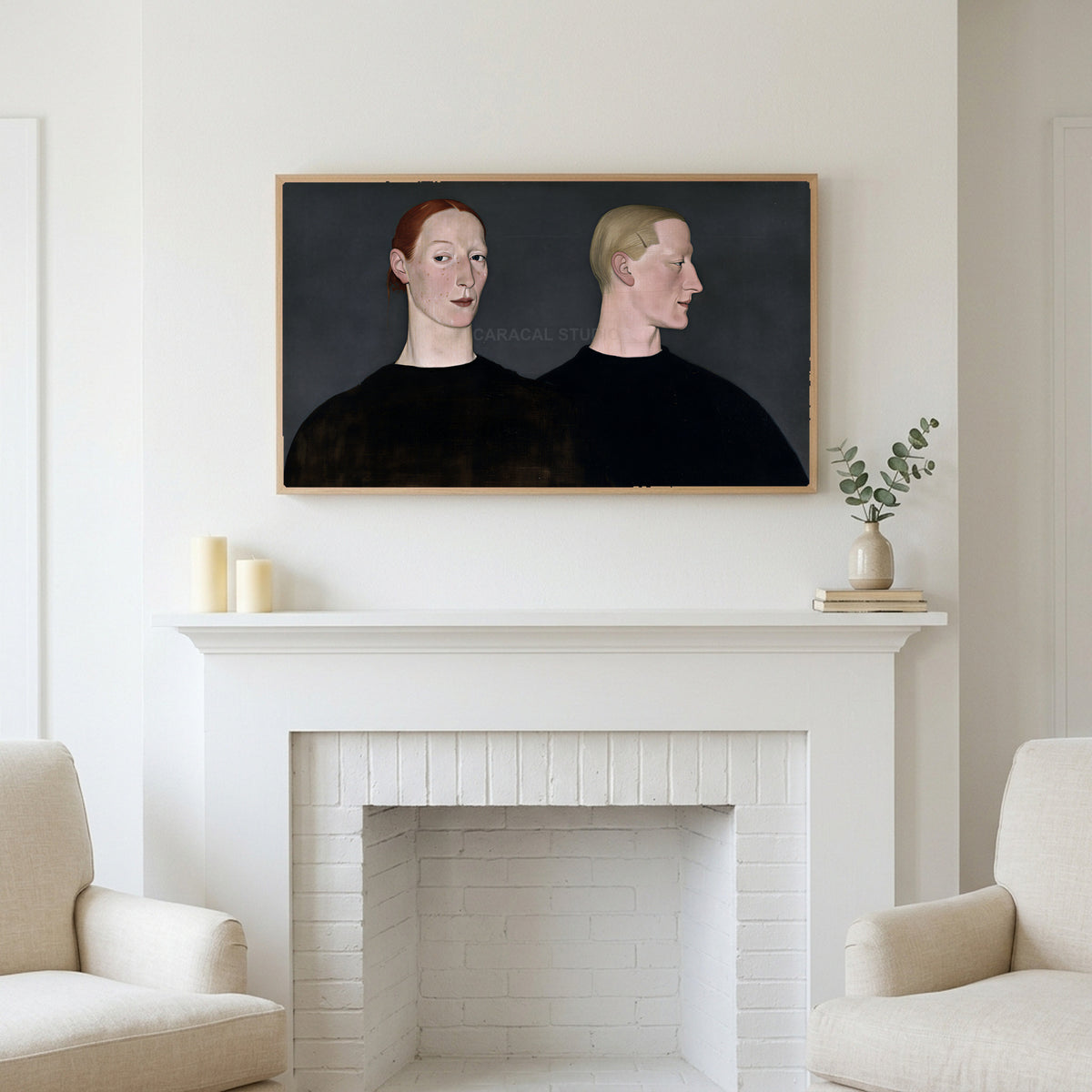 Two women portrait art above a white fireplace with candles and eucalyptus on the mantel