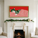 Sleeping cat and candy cane stripes art on a TV above a white fireplace with a pine garland and cream stockings