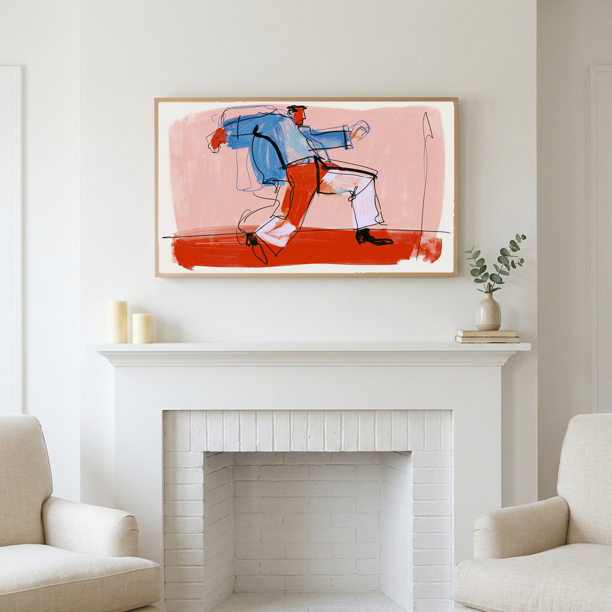 Dancing man line art above a white fireplace with candles and eucalyptus on the mantel