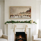 Christmas village street art on a TV above a white fireplace with a pine garland and cream stockings