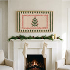 Folk Christmas tree art on a TV above a white fireplace with a pine garland and cream stockings