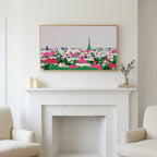 Paris skyline art above a white fireplace with candles and eucalyptus on the mantel