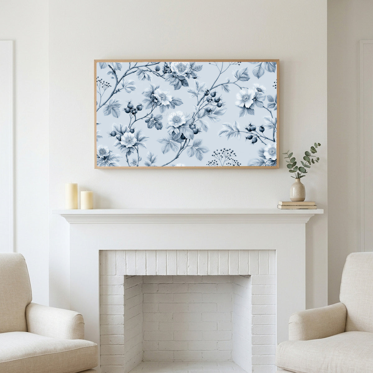 Toile wild roses art above a white fireplace with candles and eucalyptus on the mantel