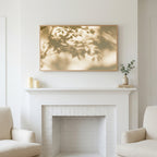 Leaf shadow art above a white fireplace with candles and eucalyptus on the mantel