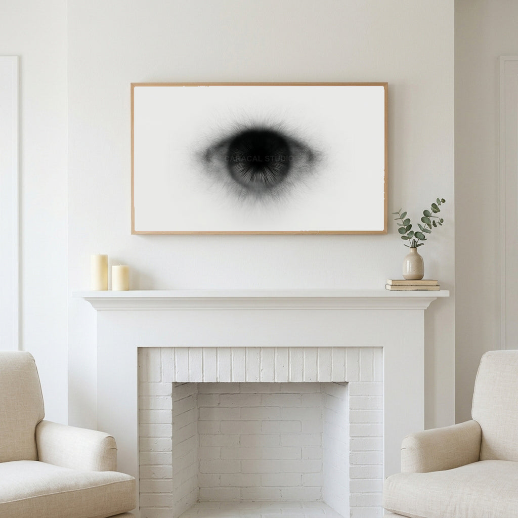 Black and white eye art above a white fireplace with candles and eucalyptus on the mantel