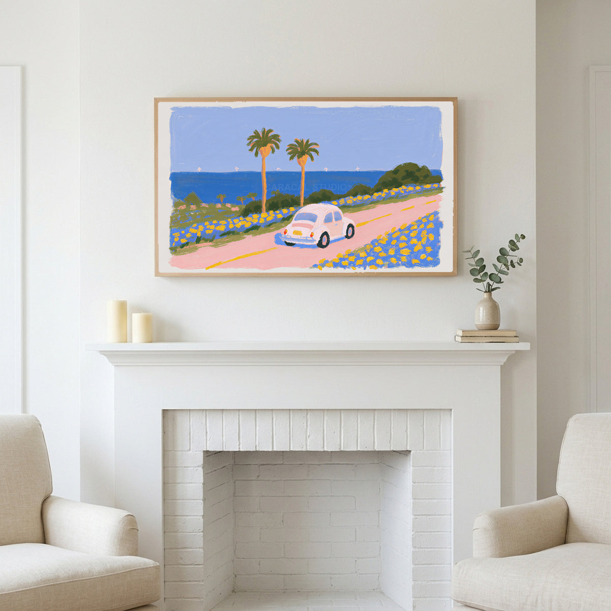 Seaside car art above a white fireplace with candles and eucalyptus on the mantel