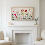 Frame TV art above a white fireplace with candles and eucalyptus on the mantel