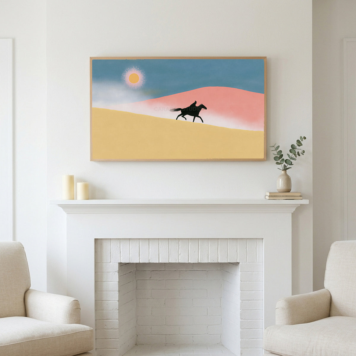Rider in the desert art above a white fireplace with candles and eucalyptus on the mantel