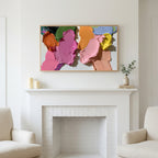 Frame TV art above a white fireplace with candles and eucalyptus on the mantel