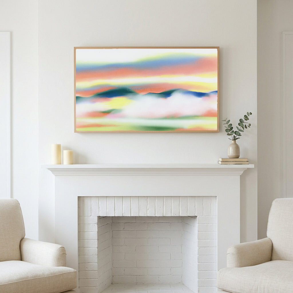Abstract sunset hills art above a white fireplace with candles and eucalyptus on the mantel