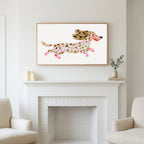 Running dachshund art above a white fireplace with candles and eucalyptus on the mantel