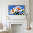 Daisy art above a white fireplace with candles and eucalyptus on the mantel