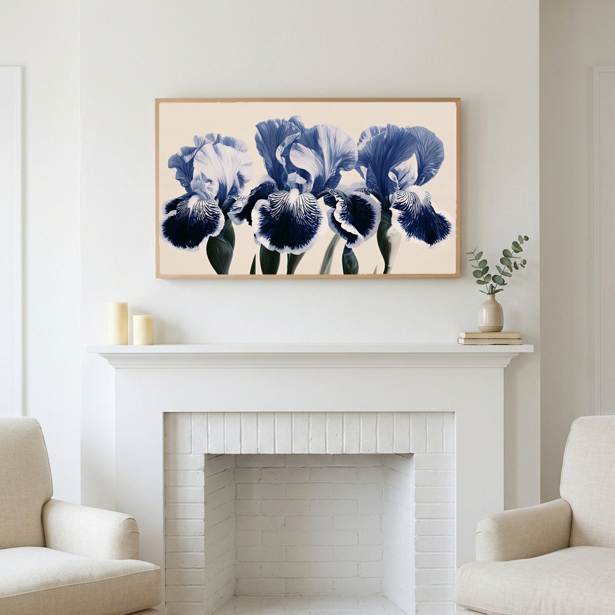 Blue iris art above a white fireplace with candles and eucalyptus on the mantel