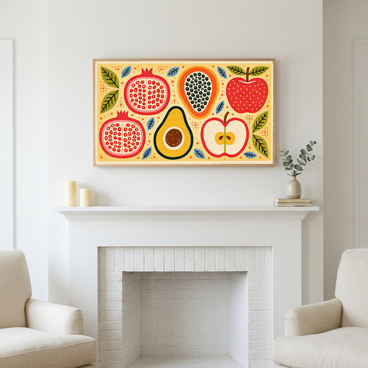 Colorful fruit halves art above a white fireplace with candles and eucalyptus on the mantel