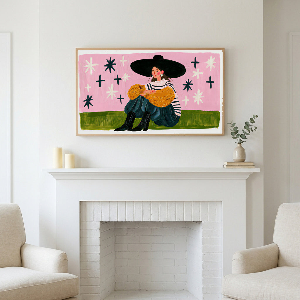 Woman in a big hat art above a white fireplace with candles and eucalyptus on the mantel