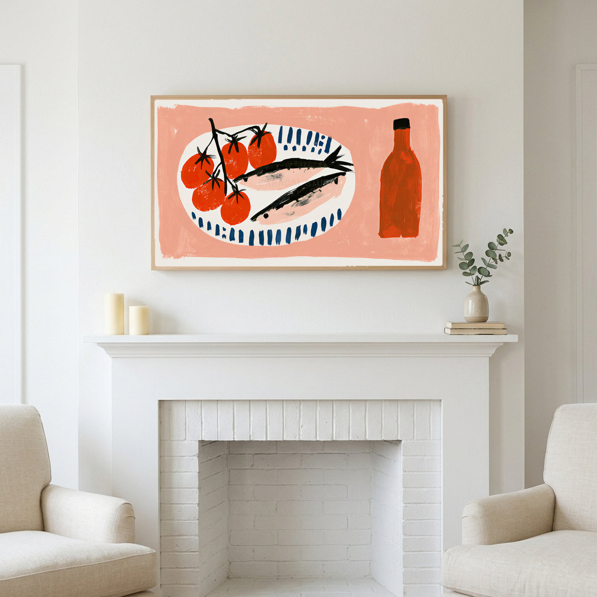 Sardines and tomatoes art above a white fireplace with candles and eucalyptus on the mantel