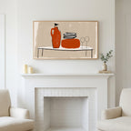 Minimalist table with jug and wine glasses art above a white fireplace with candles and eucalyptus on the mantel