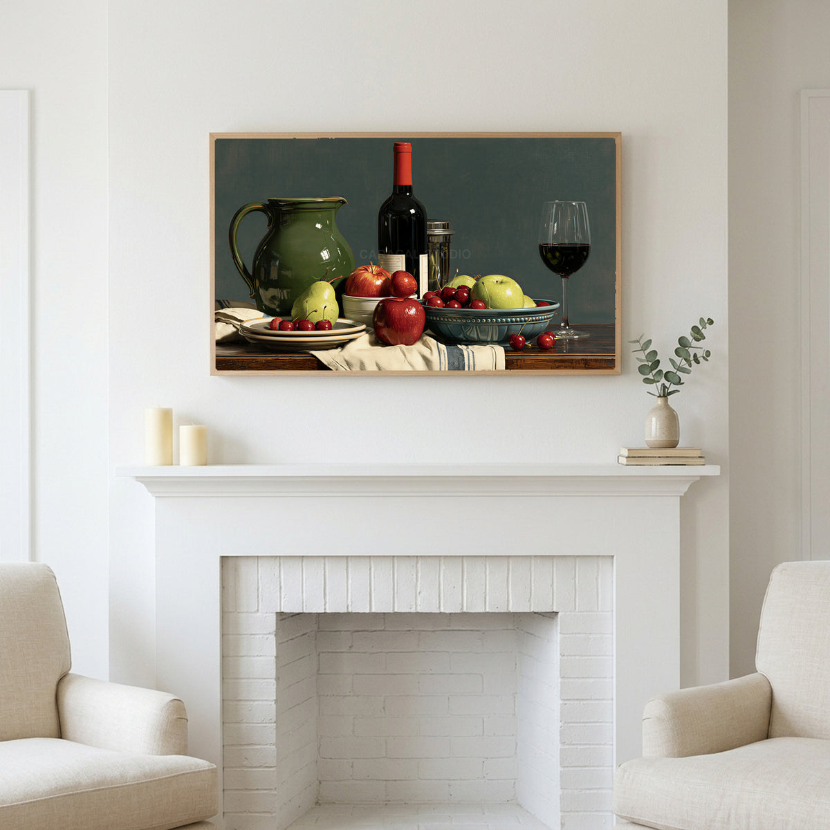 Wine and fruit still life art above a white fireplace with candles and eucalyptus on the mantel