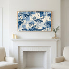 Blue botanical art above a white fireplace with candles and eucalyptus on the mantel