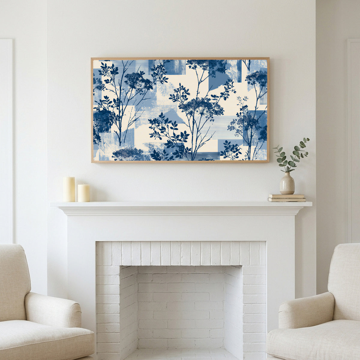 Blue botanical art above a white fireplace with candles and eucalyptus on the mantel
