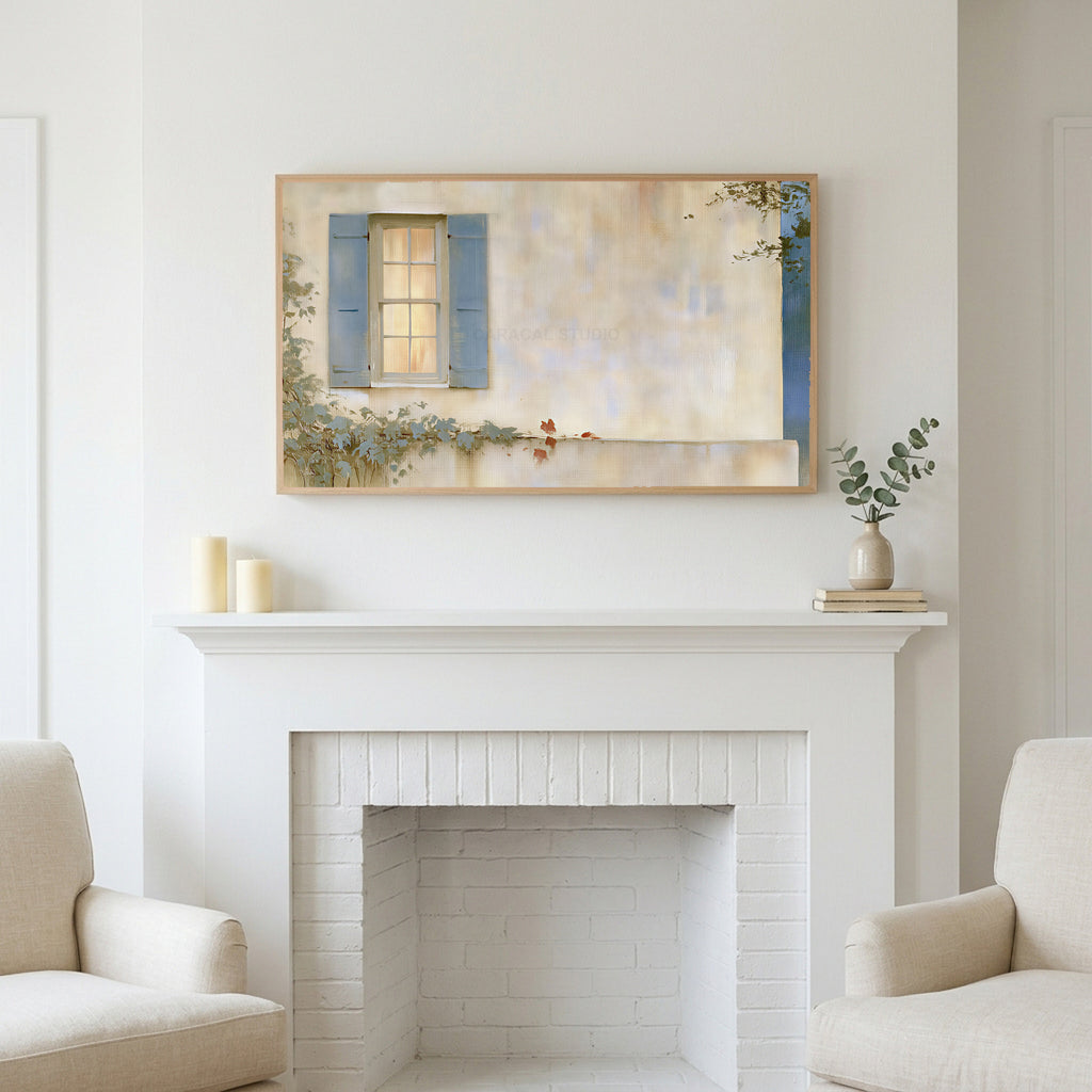Blue shutter cottage window art above a white fireplace with candles and eucalyptus on the mantel