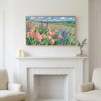 Poppy field art above a white fireplace with candles and eucalyptus on the mantel