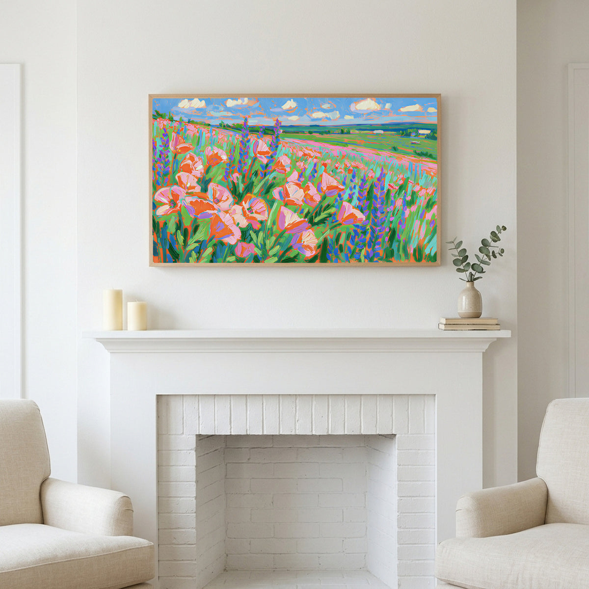 Poppy field art above a white fireplace with candles and eucalyptus on the mantel