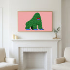 Grumpy gorilla art above a white fireplace with candles and eucalyptus on the mantel