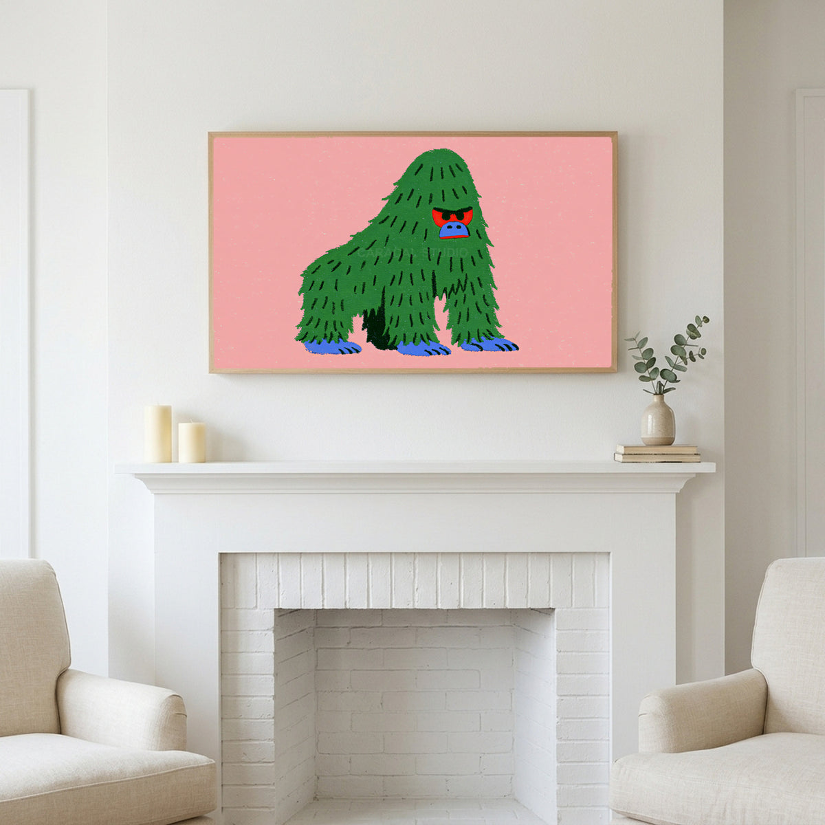 Grumpy gorilla art above a white fireplace with candles and eucalyptus on the mantel