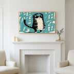Yoga cat art above a white fireplace with candles and eucalyptus on the mantel