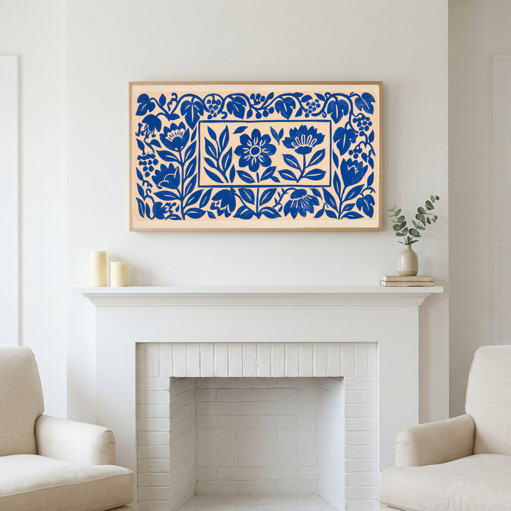 Blue paper cut flowers art above a white fireplace with candles and eucalyptus on the mantel