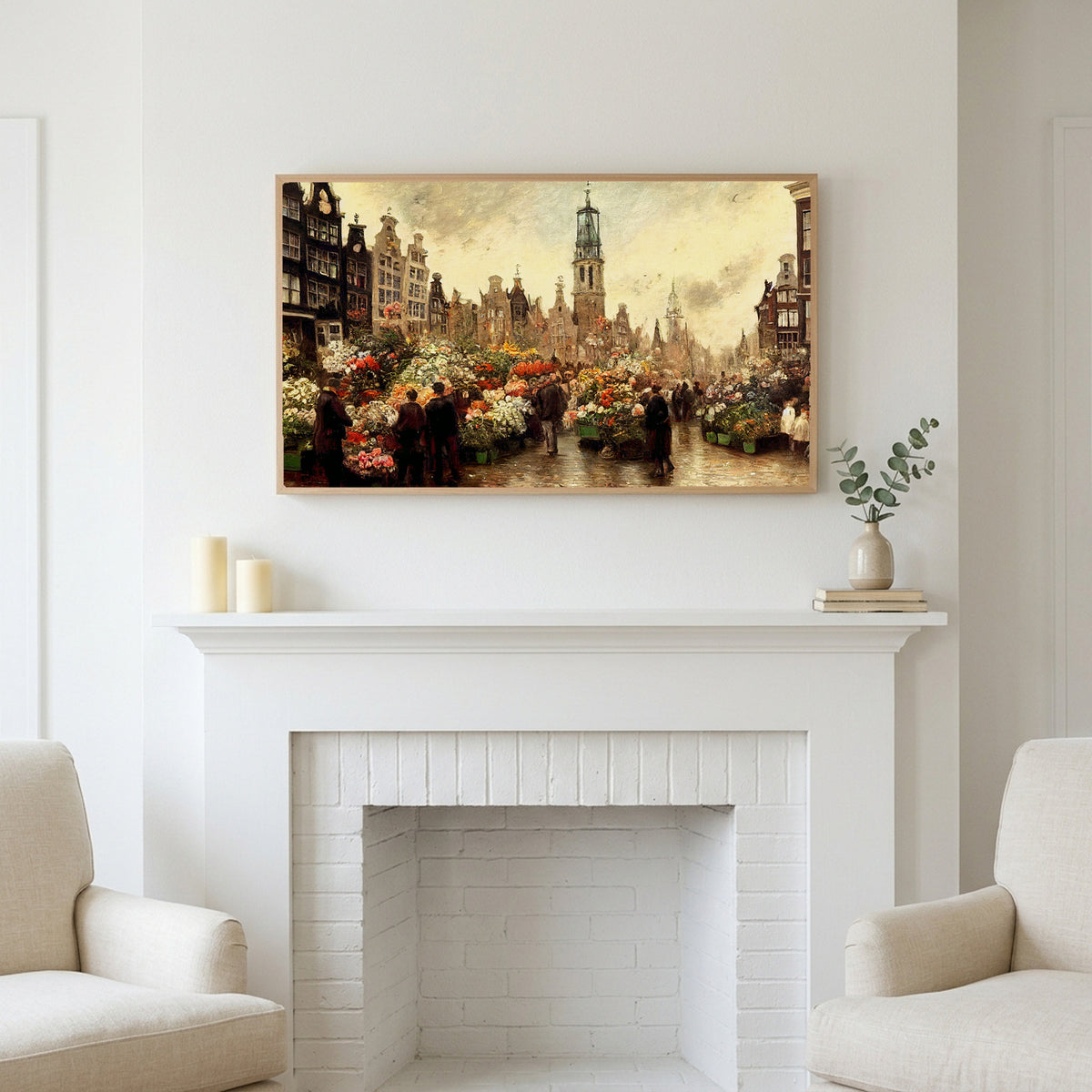 Frame TV art above a white fireplace with candles and eucalyptus on the mantel