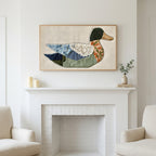 Patchwork duck art above a white fireplace with candles and eucalyptus on the mantel