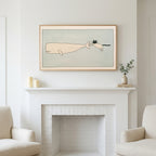 Cat and whale art above a white fireplace with candles and eucalyptus on the mantel