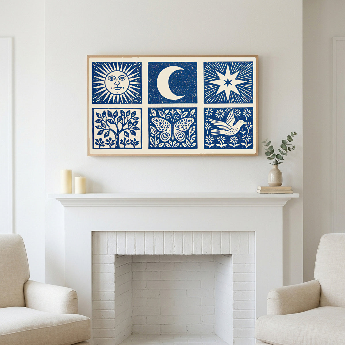 Frame TV art above a white fireplace with candles and eucalyptus on the mantel