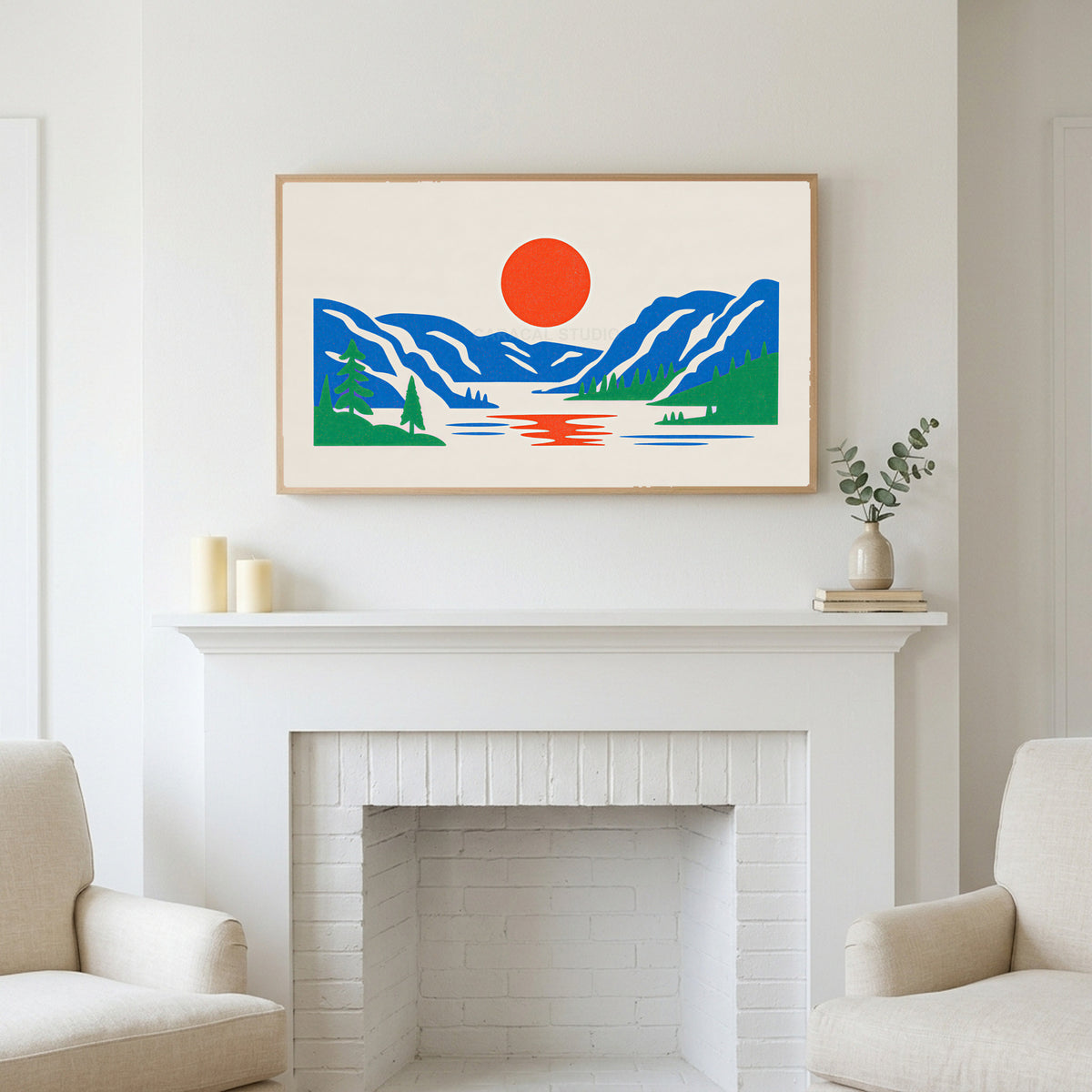 Mountain lake sun art above a white fireplace with candles and eucalyptus on the mantel