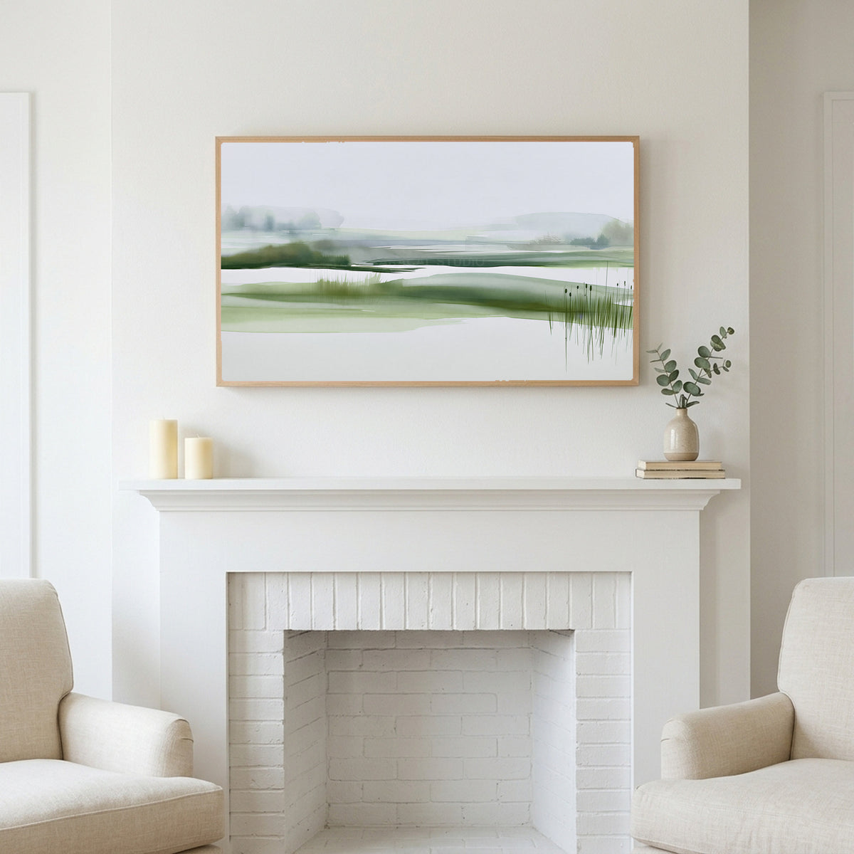 Misty wetland art above a white fireplace with candles and eucalyptus on the mantel