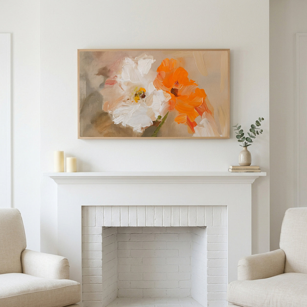 Frame TV art above a white fireplace with candles and eucalyptus on the mantel